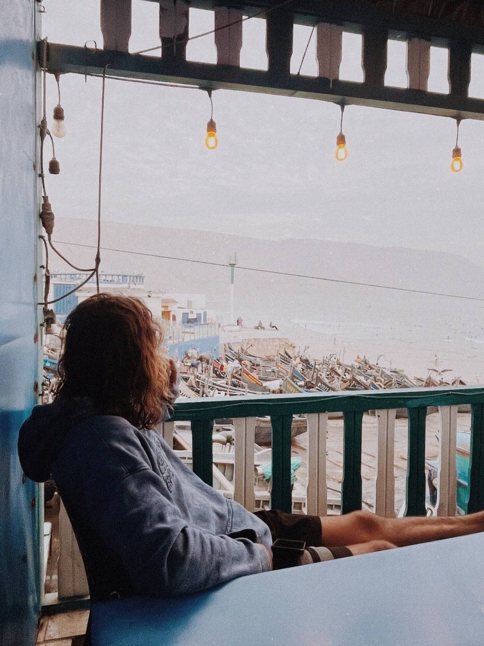 Morning on a terrace above the bay, looking at the sea and the fishing boats